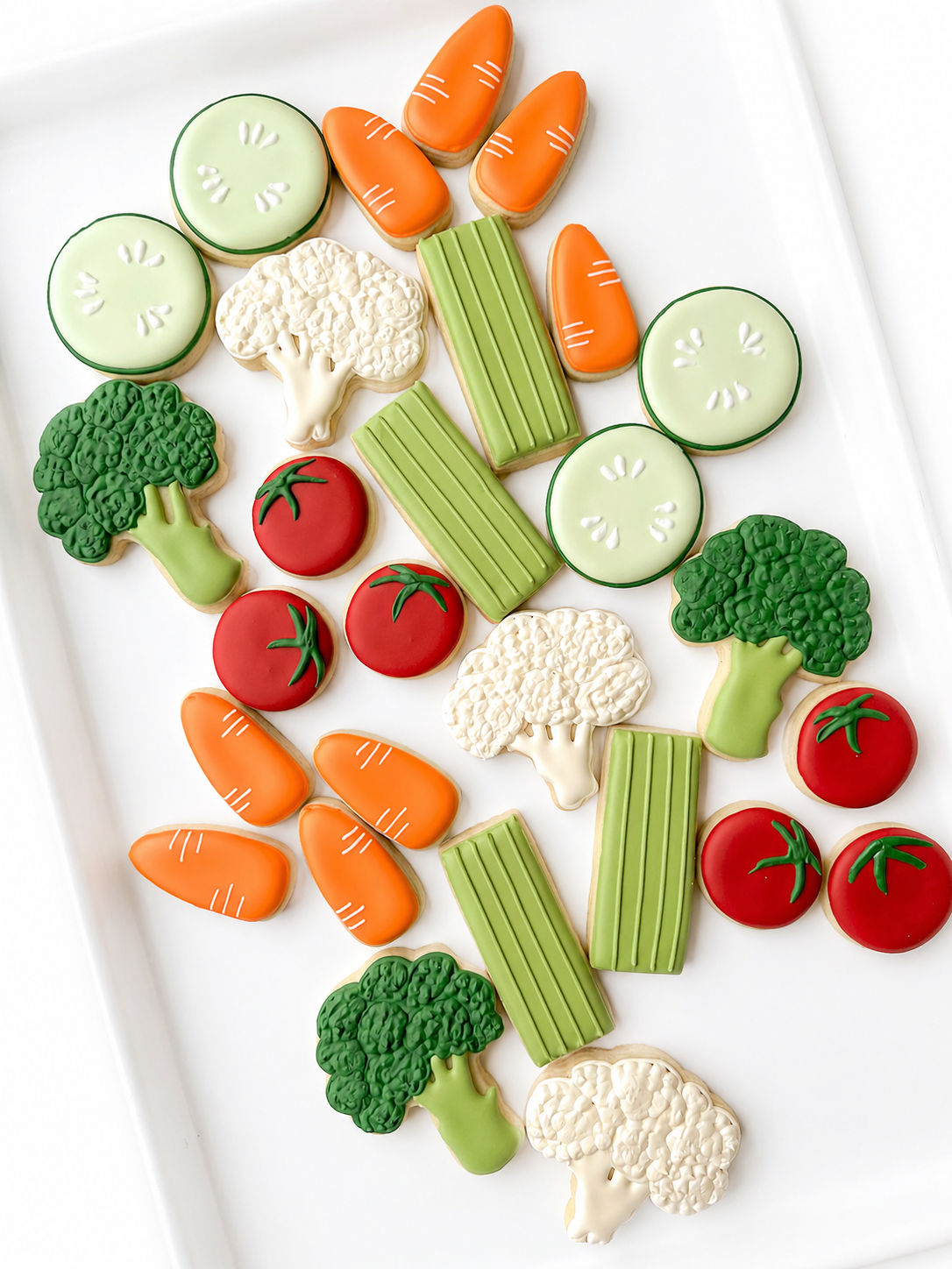 eat your veggies, cauliflower, broccoli, celery sticks, baby carrots, cherry tomatoes, cucumber slice decorated cookies