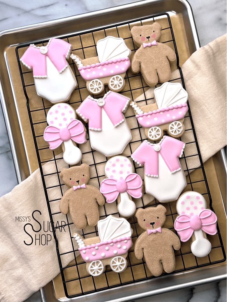 It's a girl baby shower cookies, teddy bear, onesie, rattle pink baby carriage