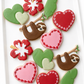 Sloth hanging from branch, sloth with heart, Love you slow much, hearts, double heart, hibiscus flower, banana leaves, hearts, valentines cookies
